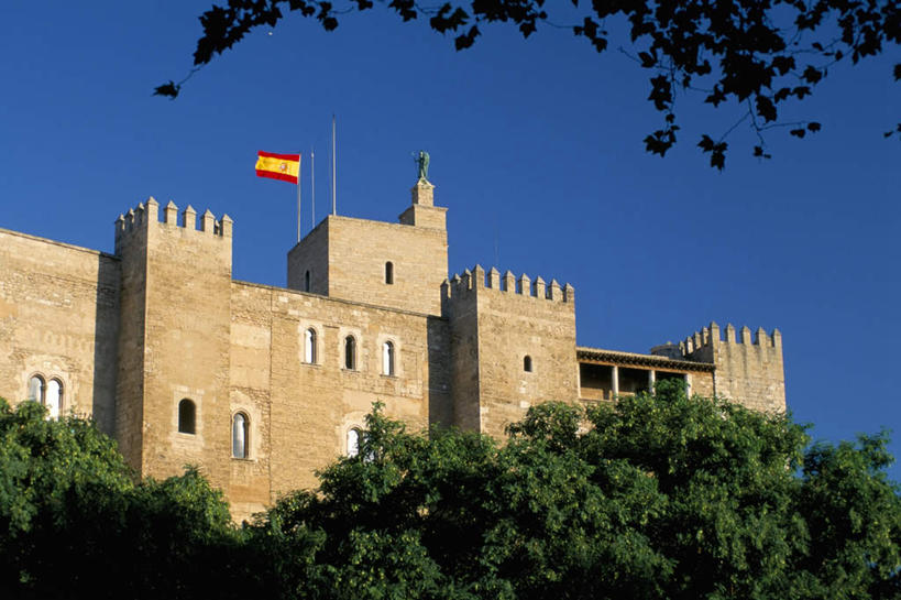 无人,家,宫殿,横图,室外,白天,仰视,旅游,度假,植物,标志建筑,地标,建筑,旗帜,国旗,西班牙,欧洲,一面,阴影,飘扬,光线,影子,房屋,屋子,公寓,娱乐,建设,洋房,楼房,住宅,树,树木,蓝色,绿色,蓝天,天空,阳光,自然,天,享受,休闲,旅游胜地,放松,生长,晴朗,成长,飘逸,南欧,飞扬,万里无云,马略卡岛,西班牙王国,巴利阿里群岛,马略卡,旗,晴空,晴空万里,彩图,低角度拍摄,房子